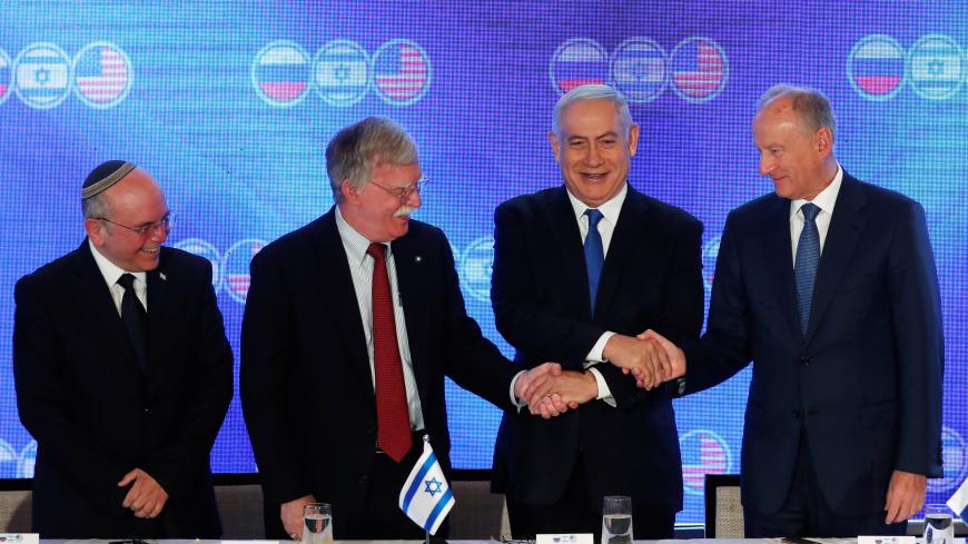 Israeli Prime Minister Benjamin Netanyahu shakes hands with U.S national security adviser John Bolton and Nikolai Patrushev, secretary of the Russian Security Council, as Israeli national security adviser Meir Ben-Shabbat stands nearby during opening statements of a trilateral meeting between American, Israeli and Russian top security advisers in Jerusalem June 25, 2019. REUTERS/Ronen Zvulun - RC1D41591EE0