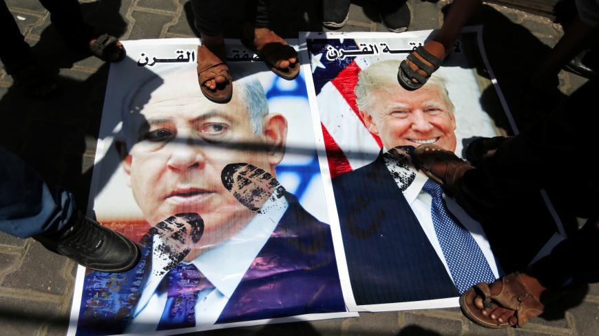 Palestinian demonstrators step on posters depicting U.S. President Donald Trump and Israeli Prime Minister Benjamin Netanyahu during a protest against Bahrain's workshop for U.S. Middle East peace plan, in the southern Gaza Strip, June 25, 2019. REUTERS/Ibraheem Abu Mustafa - RC1D646FB910
