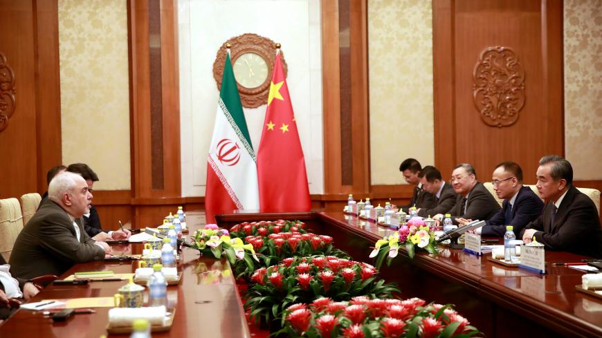 Iranian Foreign Minister Mohammad Javad Zarif (L) speaks with Chinese Foreign Minister Wang Yi (R)  during their meeting at the Diaoyutai State Guesthouse in Beijing, China August 26, 2019.  How Hwee Young/Pool via REUTERS - RC1B2858A230