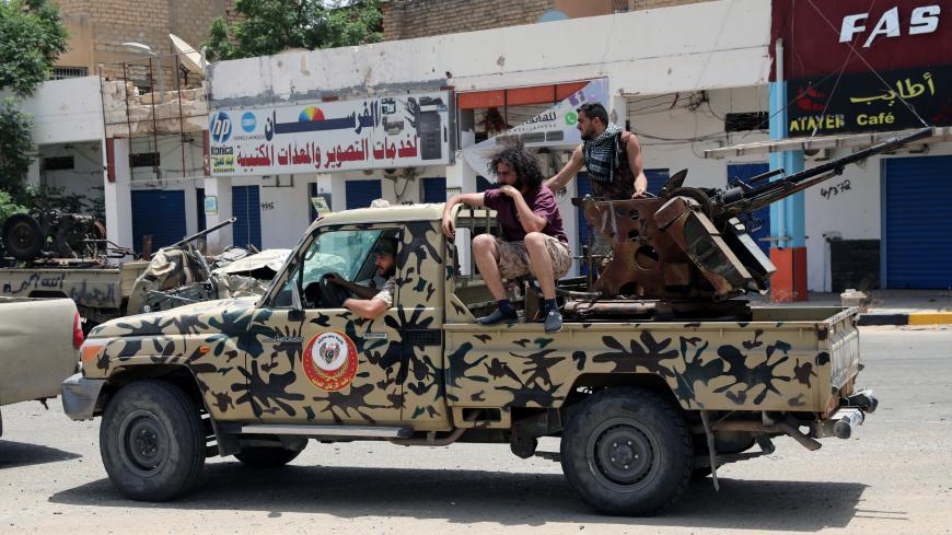 Fighters loyal to Libya's internationally recognised government are seen on military vehicle after regaining control over the city, in Tripoli, Libya, June 4, 2020. REUTERS/Ismail Zitouny - RC2D2H9TCSV0
