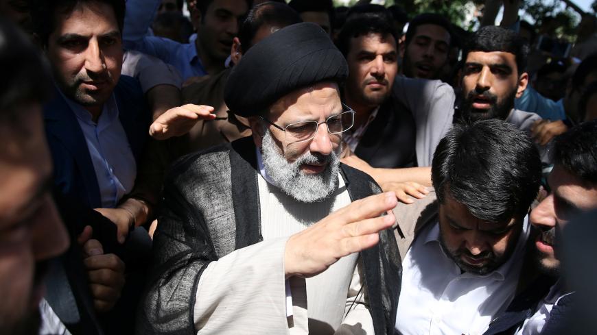 Iranian presidential candidate Ebrahim Raisi (C) arrives with crowds of supporters to cast his vote during the presidential election in Tehran, Iran, May 19, 2017. TIMA via REUTERS ATTENTION EDITORS - THIS IMAGE WAS PROVIDED BY A THIRD PARTY. FOR EDITORIAL USE ONLY. - RC115996ACD0