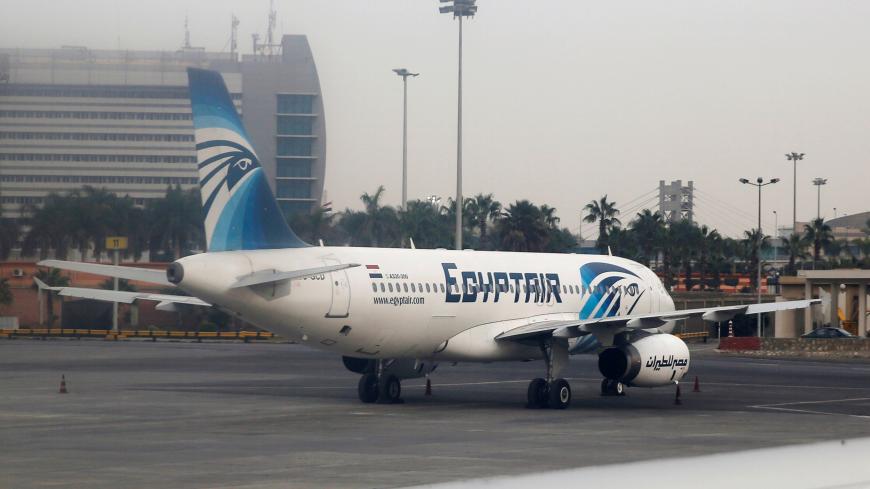 An EgyptAir A320-200 plane is pictured through the window of an Etihad Airways plane after it landed on the runway at Cairo International Airport, Egypt December 16, 2017. Picture taken December 16, 2017. REUTERS/Amr Abdallah Dalsh - RC140A9C9210