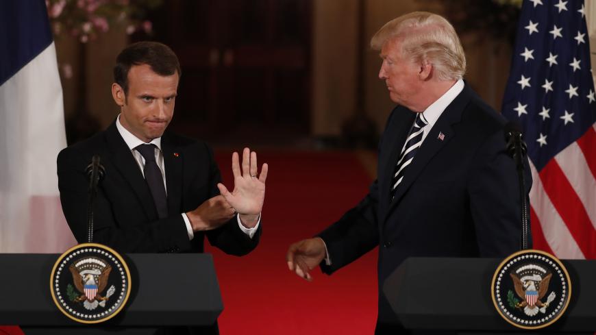 French President Emmanuel Macron waves to someone in the crowd as he and U.S. President Donald Trump conclude their joint news conference in the East Room of the White House in Washington, U.S., April 24, 2018. REUTERS/Jonathan Ernst - HP1EE4O1E9LAN