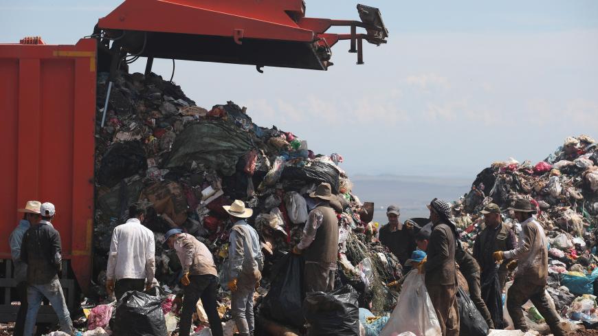 Garbage collectors look for recyclable waste at a dumping ground on World Environment Day at the outskirts of southeastern province of Diyarbakir, Turkey June 5, 2018. REUTERS/Umit Bektas - RC1546A27F00