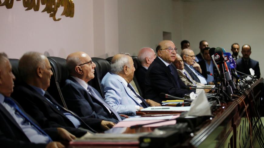 Judge Medhat al-Mahmoud, presiding over the supreme federal court, reads a verdict on appeals concerning amendment of an election law in Baghdad, Iraq June 21, 2018. REUTERS/Abdullah Dhiaa al-Deen - RC134238AFB0