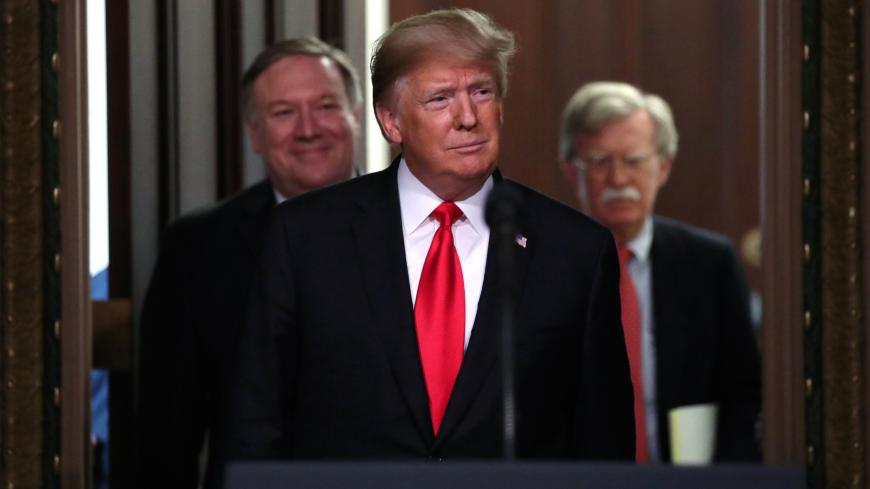 U.S. President Donald Trump arrives flanked by Secretary of State Mike Pompeo (L) and U.S. National Security Advisor John Bolton (R) for the annual meeting of the Interagency Task Force to Monitor and Combat Trafficking in Persons annual meeting at the White House in Washington, U.S., October 11, 2018. REUTERS/Jonathan Ernst - RC1E9B59B7C0