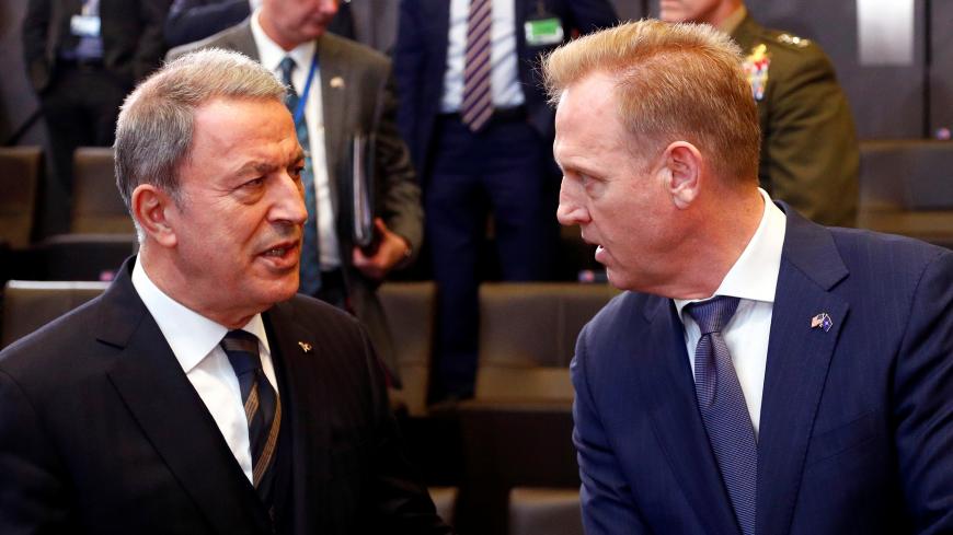 Turkey's Defence Minister Hulusi Akar talks to acting U.S. Secretary of Defense Patrick Shanahan during a NATO defence ministers meeting at the Alliance headquarters in Brussels, Belgium February 13, 2019.  REUTERS/Francois Lenoir - RC18F6D62DA0