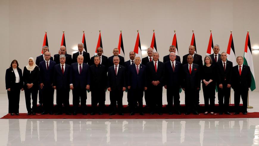 Palestinian President Mahmoud Abbas poses for a photo with members of the new Palestinian government during a swearing in ceremony, in Ramallah, in the Israeli-occupied West Bank April 13, 2019. REUTERS/Mohamad Torokman - RC1F8DE47940