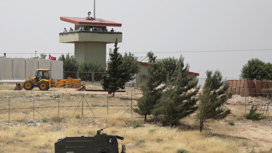 Turkish soldiers stand on a watch tower at the Atmeh crossing on the Syrian-Turkish border, as seen from the Syrian side, in Idlib governorate, Syria May 31, 2019. REUTERS/Khalil Ashawi - RC1525F30880
