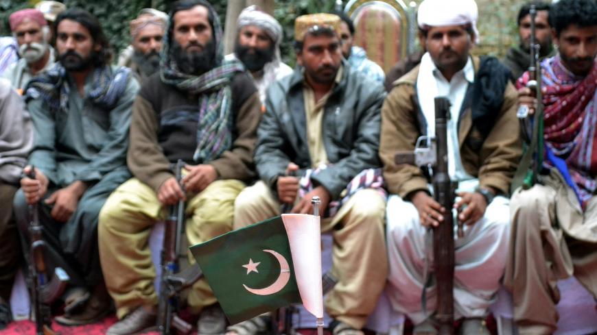 Militants from the band organization Baloch Liberation Army and United Baloch Army, sit before hand over their weapons to Chieftain of Marri tribe and Pakistan's provincial minister Nawab Changaiz Marri during a surrender ceremony in Quetta on October 29, 2015. A total of 23 militants belonging to Marri tribe have surrendered to authorities with weapons in Quetta the capital of Pakistans restive southwestern province of Balochistan. AFP PHOTO/Banaras KHAN        (Photo credit should read BANARAS KHAN/AFP/Ge