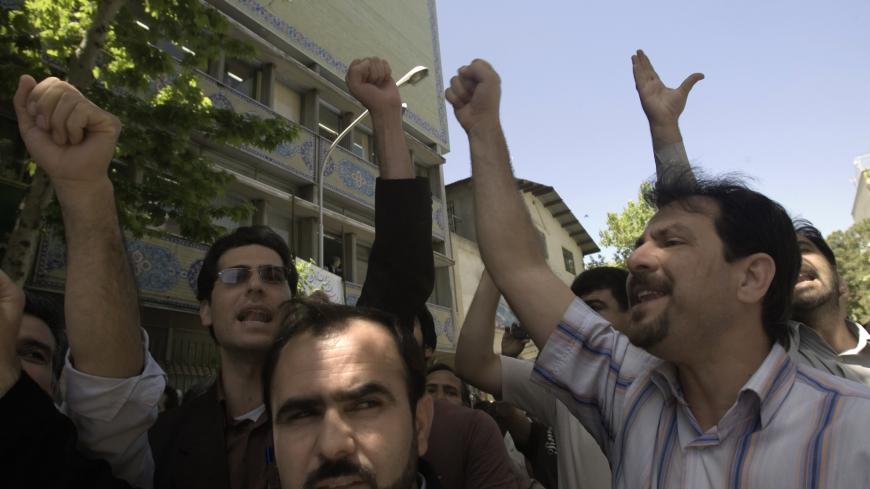 Iranian teachers take part in a rally asking for better pay in front of a Education Ministry building in Tehran May 2, 2007. REUTERS/Raheb Homavandi (IRAN) - GM1DVEBAWXAA