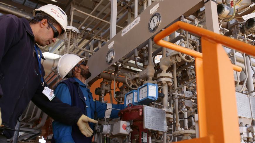 Technicians inspect the Krechba gas treatment plant, about 1200 km (746 miles) south of Algiers December 14, 2008. Algeria has approved or plans to approve projects expected to bring on up to 110,000 barrels per day (bpd) of crude oil output and 100,000 bpd of oil equivalents by 2012 or 2013, a Sonatrach official said on Sunday. REUTERS/Zohra Bensemra (ALGERIA) - GM1E4CF0CLZ01