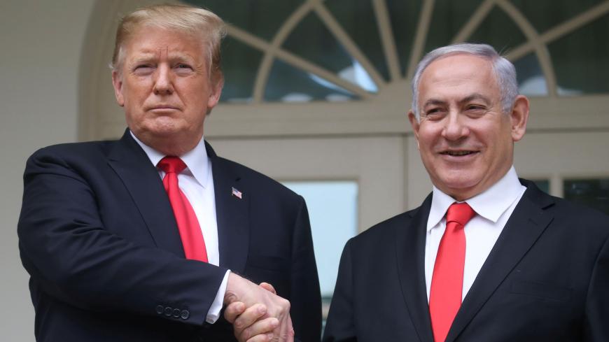 U.S. President Donald Trump shakes hands with Israel's Prime Minister Benjamin Netanyahu as they pose on the West Wing colonnade in the Rose Garden at the White House in Washington, U.S., March 25, 2019. REUTERS/Leah Millis - RC1AE2447D80