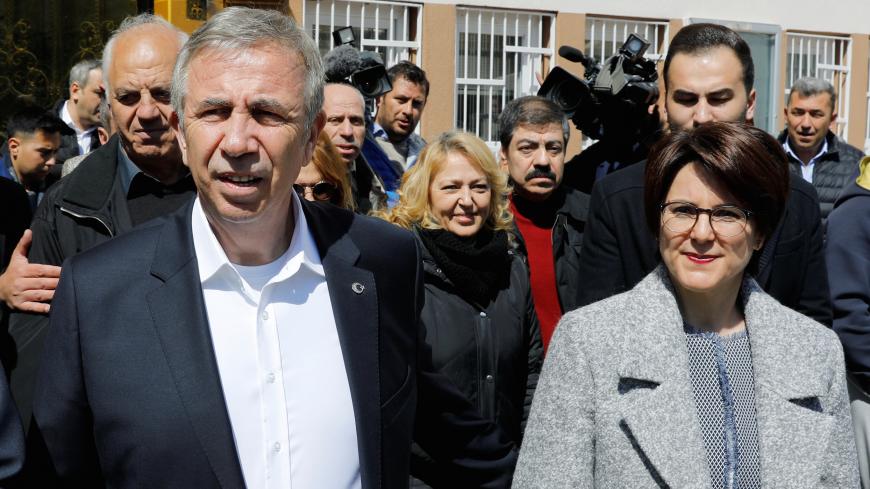 Mansur Yavas, mayoral candidate of the main opposition Republican People's Party (CHP) and his wife Nursen Yavas, leave a polling station after casting votes during the municipal elections in Ankara, Turkey, March 31, 2019. REUTERS/Umit Bektas - RC1BCB6685D0