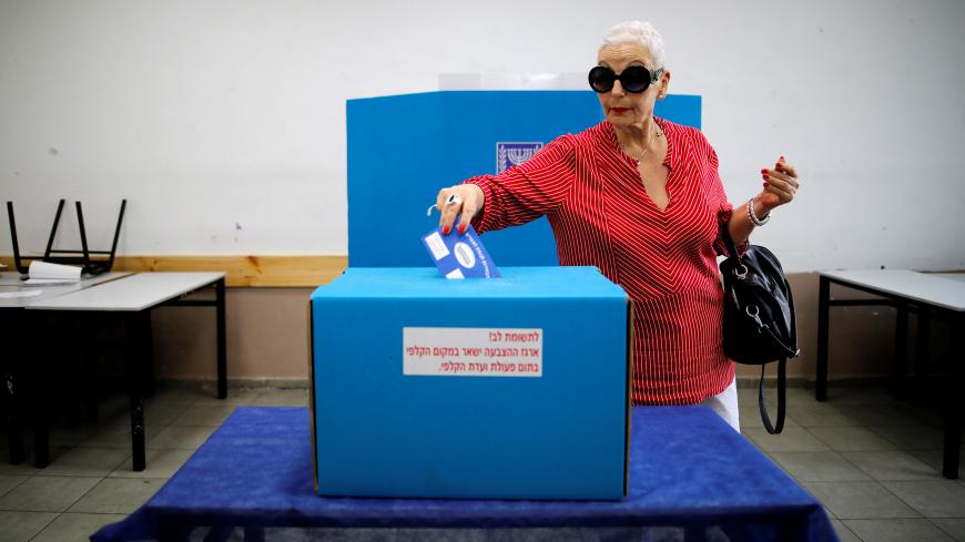 A woman casts her ballot as Israelis vote in a parliamentary election, at a polling station in Tel Aviv, Israel April 9, 2019. REUTERS/Corinna Kern - RC1166A61B30