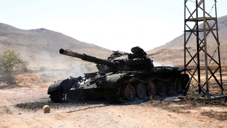 REFILE - CORRECTING GRAMMAR A destroyed and burnt tank, that belongs to the eastern forces led by Khalifa Haftar, is seen in Gharyan south of Tripoli Libya June 27, 2019. REUTERS/Ismail Zitouny - RC1D103F7D50