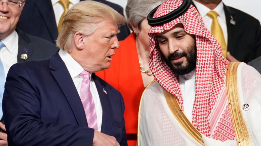 U.S. President Donald Trump speaks with Saudi Arabia's Crown Prince Mohammed bin Salman during family photo session with other leaders and attendees at the G20 leaders summit in Osaka, Japan, June 28, 2019.  REUTERS/Kevin Lamarque - RC187E92FB00