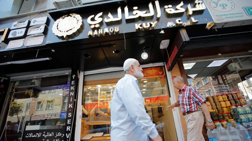 People walk past by a Syrian jewelry shop in Istanbul's Kucukcekmece district, Turkey, July 5, 2019. Picture taken July 5, 2019. REUTERS/Kemal Aslan - RC1445C61E60