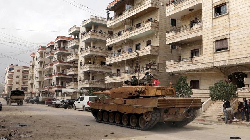 Turkish soldiers ride on a military vehicle in the center of Afrin, Syria March 24, 2018. REUTERS/Khalil Ashawi - RC1B6933DB00