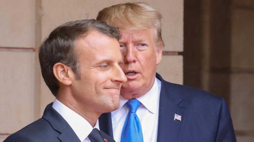 French President Emmanuel Macron speaks with U.S. President Donald Trump ahead of a meeting at the Prefecture of Caen, on the sidelines of D-Day commemorations marking the 75th anniversary of the World War II Allied landings in Normandy, France,  June 6, 2019. Ludovic Marin/Pool via REUTERS - RC13F1587560