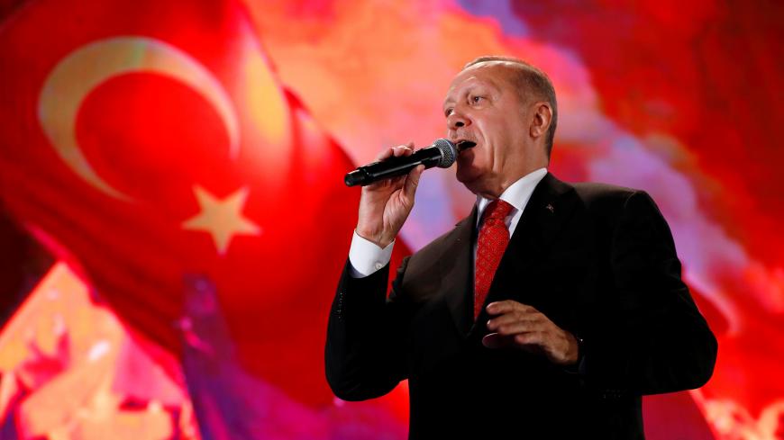 Turkish President Tayyip Erdogan addresses his supporters during a ceremony marking the third anniversary of the attempted coup at Ataturk Airport in Istanbul, Turkey, July 15, 2019. REUTERS/Murad Sezer - RC1C09129690