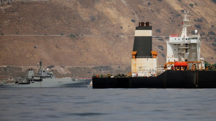 A British Royal Navy patrol vessel guards the Iranian oil tanker Grace 1 as it sits anchored anchored after it was seized earlier this month by British Royal Marines off the coast of the British Mediterranean territory on suspicion of violating sanctions against Syria, in the Strait of Gibraltar, southern Spain July 20, 2019. REUTERS/Jon Nazca - RC1FBC24FCC0