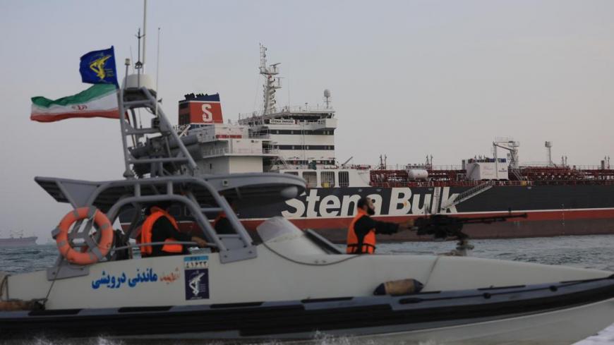 A boat of Iranian Revolutionary Guard sails next to Stena Impero, a British-flagged vessel owned by Stena Bulk, at Bandar Abbas port, in this undated handout photo. Iran, ISNA/WANA Handout via REUTERS ATTENTION EDITORS - THIS IMAGE WAS PROVIDED BY A THIRD PARTY. - RC1B8D53F530