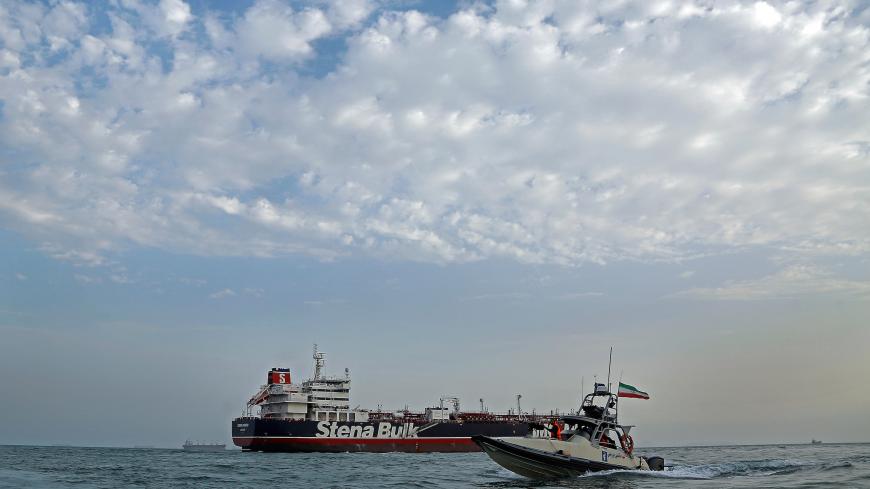 A boat of the Iranian Revolutionary Guard sails next to Stena Impero, a British-flagged vessel owned by Stena Bulk, at Bandar Abbas port, July 21, 2019. Picture taken July 21, 2019. Iran, Mizan News Agency/WANA Handout via REUTERS ATTENTION EDITORS - THIS IMAGE WAS PROVIDED BY A THIRD PARTY. - RC1EE6EC1840