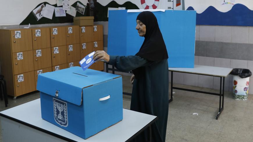 An Arab Israeli woman casts her vote during Israel's parliamentary elections on April 9, 2019 at a polling station in the northern Israeli town of Taiyiba. - Israelis voted today in a high-stakes election that will decide whether to extend Prime Minister Benjamin Netanyahu's long right-wing tenure despite corruption allegations or to replace him with an ex-military chief new to politics. (Photo by Ahmad GHARABLI / AFP)        (Photo credit should read AHMAD GHARABLI/AFP/Getty Images)