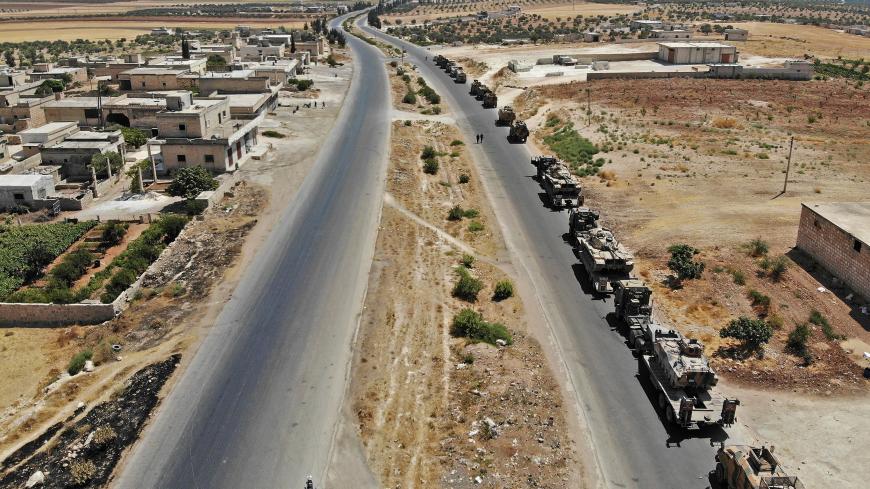 A convoy of Turkish military vehicles is pictured near the town of Maar Hitat in northern Syria's Idlib province on August 19, 2019. - A Turkish military convoy crossed into northwest Syria today, heading towards a key town where regime forces are waging fierce battles with jihadists and rebels. (Photo by Omar HAJ KADOUR / AFP)        (Photo credit should read OMAR HAJ KADOUR/AFP/Getty Images)