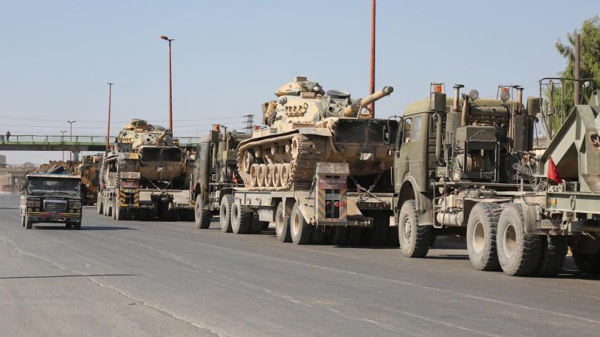 IDLIB, SYRIA - AUGUST 19: Turkish military convoy is seen on August 19, 2019 in Syria's northern province of Idlib. Syrian regime launches airstrikes on Maarat Al-Numan town as a convoy of Turkish military vehicles passes through the town. An airstrike killed three civilians and injured 12 others during a transfer to Turkeys observation point in Syrias Idlib. 
 (Photo by Izzettin Idilbi/Anadolu Agency via Getty Images)