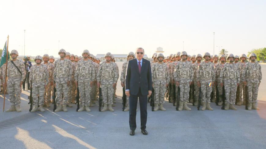DOHA, QATAR - NOVEMBER 15: President of Turkey Recep Tayyip Erdogan poses for a photo with soldiers during his visit at the Qatari-Turkish Armed Forces Land Command base in Doha, Qatar on November 15, 2017.  (Photo by Kayhan Ozer/Anadolu Agency/Getty Images)