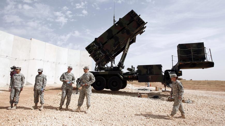 U.S. soldiers stand beside a U.S. Patriot missile system at a Turkish military base in Gaziantep, southeastern Turkey, October 10, 2014. NATO Secretary-General Jens Stoltenberg of Norway is expected to visit U.S. patriot troops in Gaziantep later in the day. REUTERS/Osman Orsal (TURKEY - Tags: POLITICS MILITARY CONFLICT) - GM1EAAA1BJP01