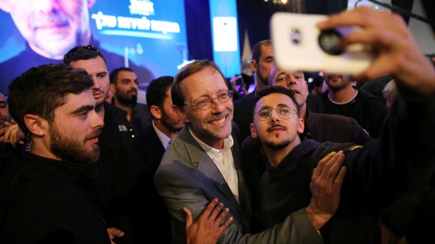Moshe Feiglin, leader of Zehut, an ultra-nationalist religious party, poses for a selfie with supporters at an election campaign event in Tel Aviv, Israel April 2, 2019. Picture taken April 2, 2019. REUTERS/Corinna Kern - RC1FE25CD6B0