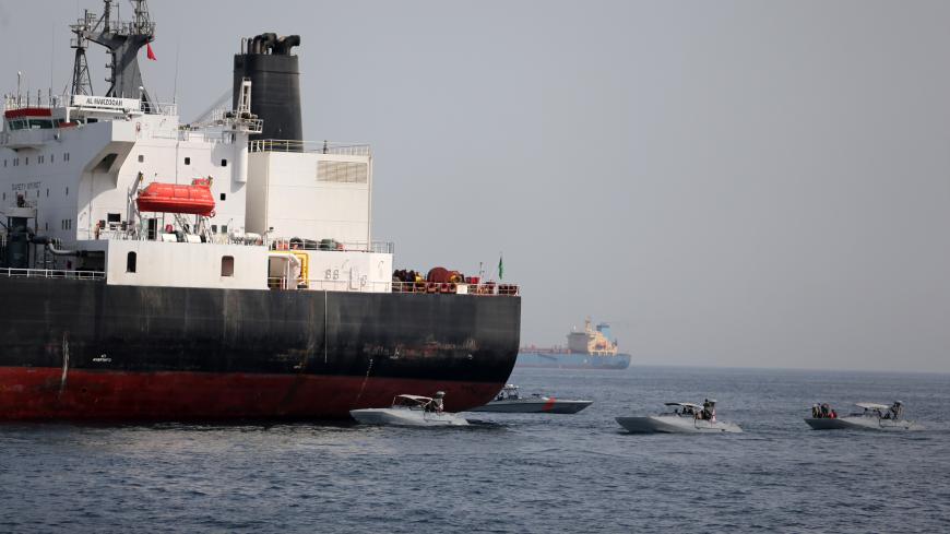 UAE Navy boats are seen next to Al Marzoqah, Saudi Arabian tanker, off the Port of Fujairah, UAE May 13, 2019.REUTERS/Satish Kumar - RC1AA0D0CE30