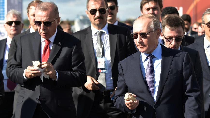 Russian President Vladimir Putin and his Turkish counterpart Recep Tayyip Erdogan taste ice-cream as they visit the MAKS 2019 air show in Zhukovsky, outside Moscow, Russia, August 27, 2019.  Sputnik/Aleksey Nikolskyi/Kremlin via REUTERS ATTENTION EDITORS - THIS IMAGE WAS PROVIDED BY A THIRD PARTY. - RC1C56375CC0