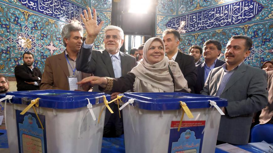 Iranian former vice president and candidate for parliamentary election Mohammad Reza Aref waves after casting his ballot with his wife (C) during elections for the parliament and Assembly of Experts, which has the power to appoint and dismiss the supreme leader, in Tehran February 26, 2016.  REUTERS/Raheb Homavandi/TIMA  ATTENTION EDITORS - THIS IMAGE WAS PROVIDED BY A THIRD PARTY. FOR EDITORIAL USE ONLY. - GF10000324086