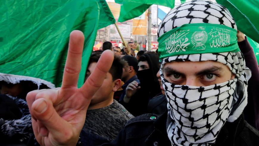 A Palestinian Hamas supporter gestures during a rally marking the 31st anniversary of Hamas' founding, in Nablus in the Israeli-occupied West Bank December 14, 2018. REUTERS/Abed Omar Qusini - RC1B09A1B080