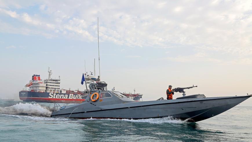 A boat of the Iranian Revolutionary Guard sails next to Stena Impero, a British-flagged vessel owned by Stena Bulk, at Bandar Abbas port, July 21, 2019. Picture taken July 21, 2019. Iran, Mizan News Agency/WANA Handout via REUTERS ATTENTION EDITORS - THIS IMAGE WAS PROVIDED BY A THIRD PARTY. - RC179FE53860