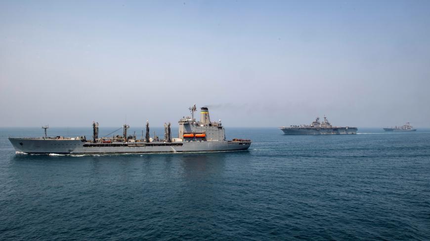 Fleet replenishment oiler USNS Big Horn (L), amphibious assault ship USS Boxer (C), and fleet replenishment oiler USNS Tippecanoe transit the Arabian Gulf, according to the U.S. Navy in this picture released on July 24, 2019. Kyle Carlstrom/U.S. Navy/Handout via REUTERS ATTENTION EDITORS- THIS IMAGE HAS BEEN SUPPLIED BY A THIRD PARTY. - RC1A0335D650
