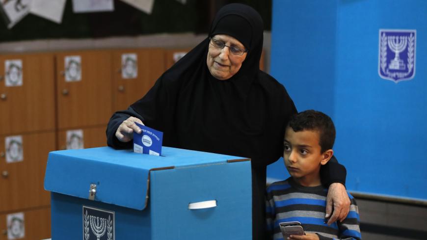 An Arab Israeli woman casts her vote during Israel's parliamentary elections on April 9, 2019 at a polling station in the northern Israelii town of Taiyiba. - Israelis voted today in a high-stakes election that will decide whether to extend Prime Minister Benjamin Netanyahu's long right-wing tenure despite corruption allegations or to replace him with an ex-military chief new to politics. (Photo by Ahmad GHARABLI / AFP)        (Photo credit should read AHMAD GHARABLI/AFP/Getty Images)