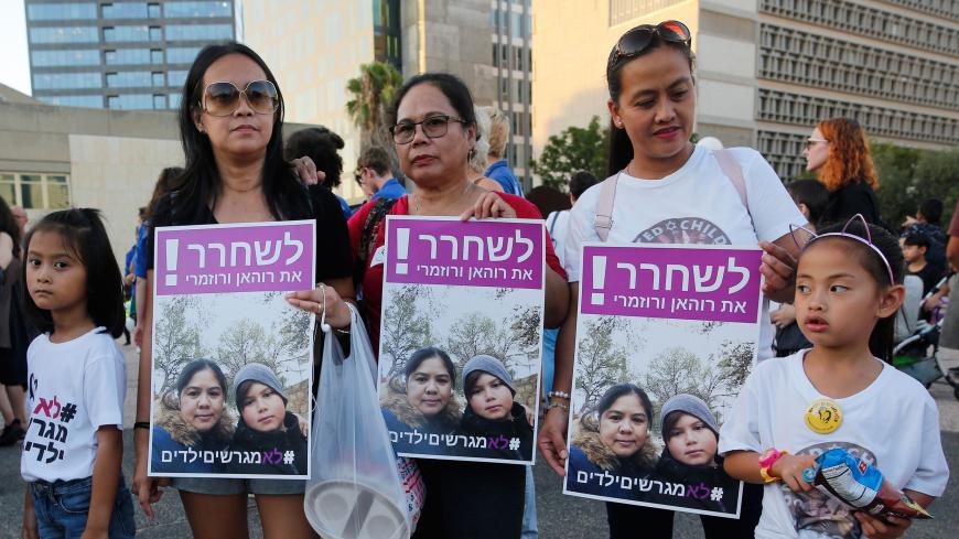 Filipino children and their mothers carry a banner which reads in Hebrew  "release Filipina mother and her son" during a protest against deportation in Tel Aviv on August 6, 2019. - Hundreds of people demonstrated in Israel against the deportation of Filipino children born in Israel from migrant workers but without any legal status. (Photo by Gil COHEN-MAGEN / AFP)        (Photo credit should read GIL COHEN-MAGEN/AFP/Getty Images)