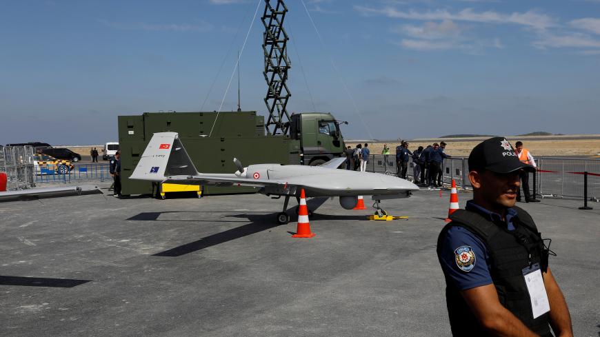 A police oficer stands next to an unmanned aerial vehicle (UAV) during Teknofest airshow at the city's new airport under construction in Istanbul, Turkey September 22, 2018. REUTERS/Umit Bektas - RC1D5D404840
