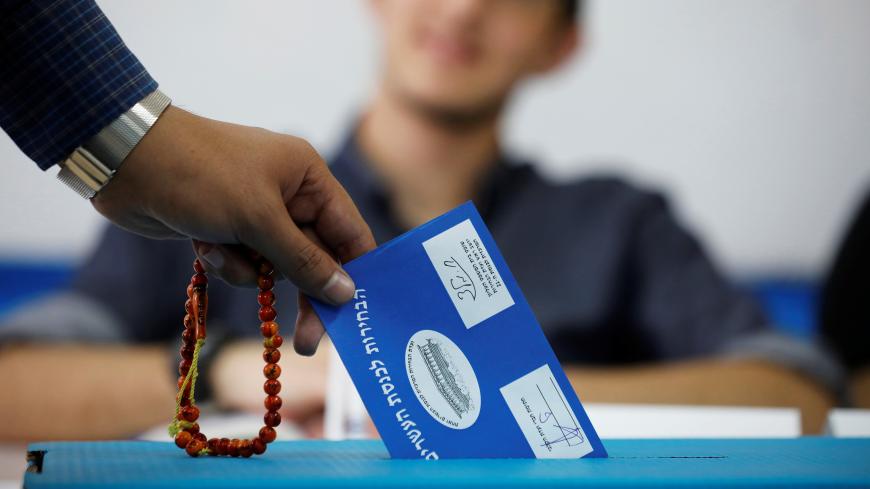 A man holds prayer beads while casting his ballot as Israelis began voting in a parliamentary election, at a polling station in the Bedouin city of Rahat in Israel's southern Negev Desert April 9, 2019. REUTERS/Amir Cohen - RC1EA7EA6CE0