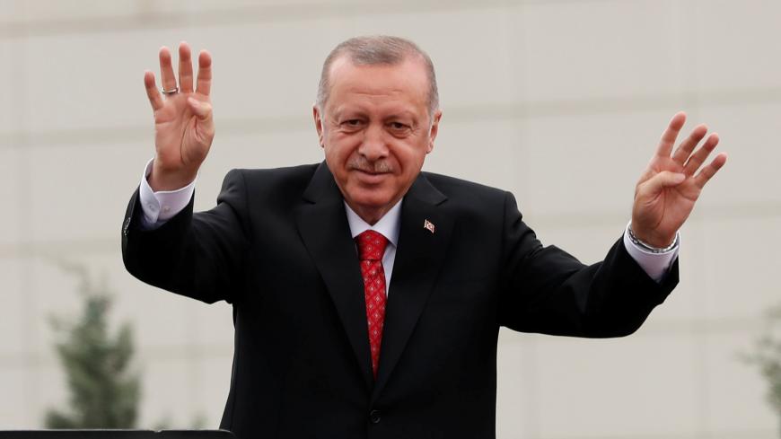 Turkish President Tayyip Erdogan greets his supporters during a ceremony in Istanbul, Turkey, June 19, 2019. REUTERS/Murad Sezer - RC1905AECB00