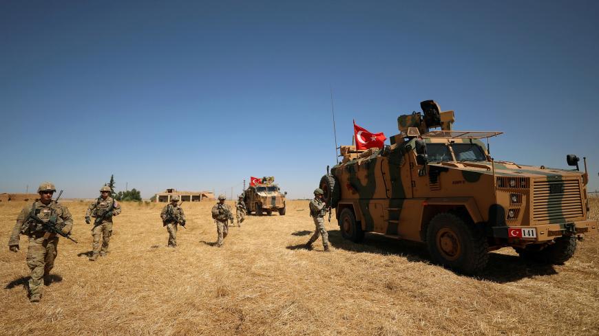 American and Turkish soldiers walk together during a joint U.S.-Turkey patrol, near Tel Abyad, Syria September 8, 2019. REUTERS/Rodi Said - RC15B521C410