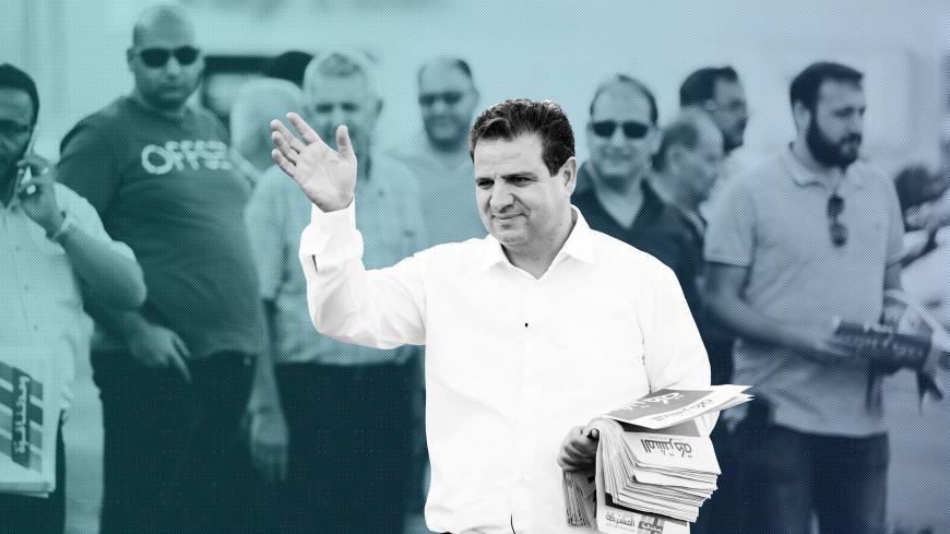Ayman Odeh, leader of the Joint List, gestures as he hands out pamphlets during an an election campaign event in Tira, northern Israel September 5, 2019. Picture taken September 5, 2019. REUTERS/Amir Cohen - RC131423B620