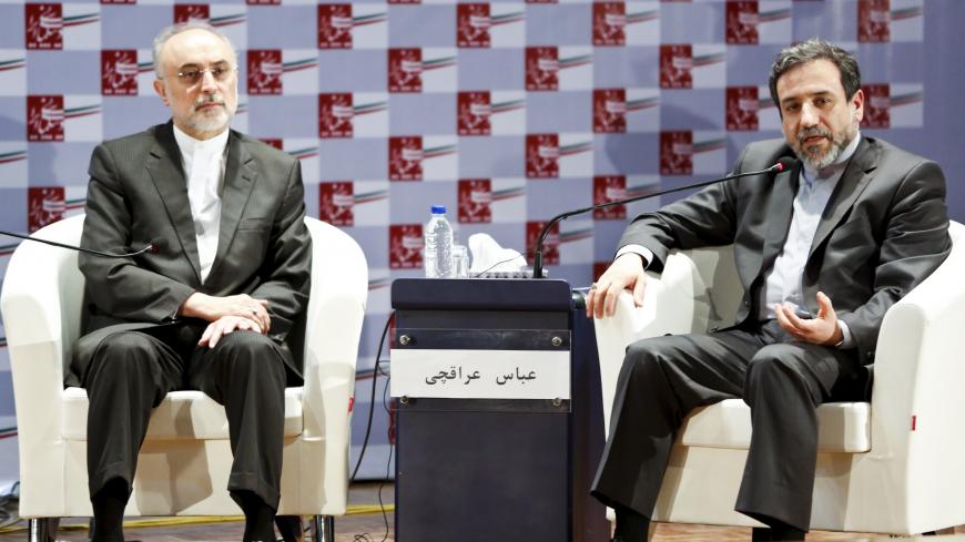 Iran's chief nuclear negotiator Abbas Araghchi (R) speaks as the head of the country's Atomic Energy Organization, Ali Akbar Salehi, listens during a nuclear deal review meeting in Tehran August 9, 2015. Dozens of companies tied to Iran's elite Revolutionary Guards, a military force commanding a powerful industrial empire with huge political influence, will win sanctions relief under a nuclear deal agreed with world powers. REUTERS/Raheb Homavandi/TIMA ATTENTION EDITORS - THIS PICTURE WAS PROVIDED BY A THIR