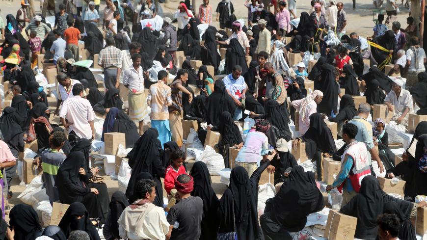 Internally displaced people gather to collect food aid from an ICRC aid distribution centre in Bajil, Yemen December 13, 2018, 2018. Picture taken December 13, 2018. REUTERS/Abduljabbar Zeyad - RC14633000A0