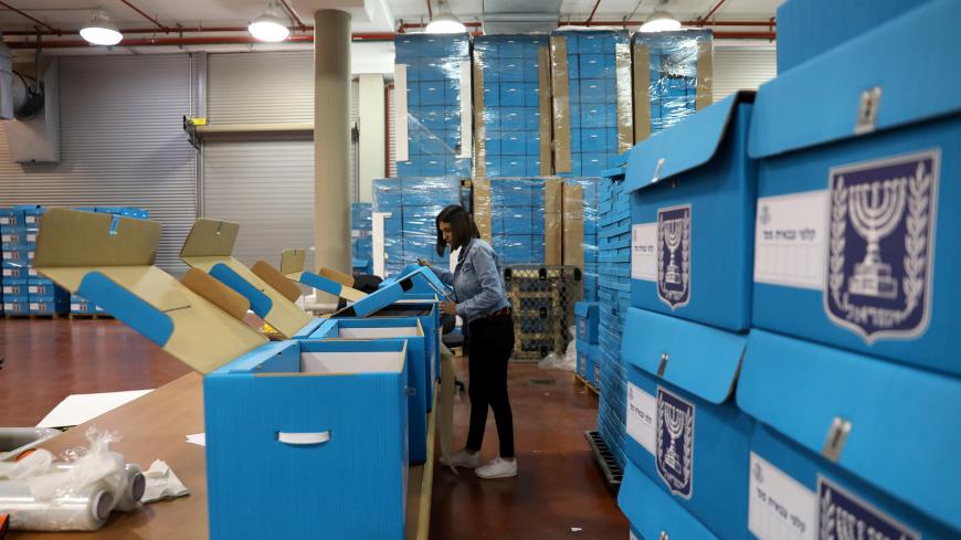 A woman sorts ballot boxes as part of preparations for the upcoming Israeli election, during a briefing for members of the media at the Israel Central Election Committee Logistics Center in Shoham, Israel March 6, 2019. REUTERS/Ammar Awad - RC194FCE0D70